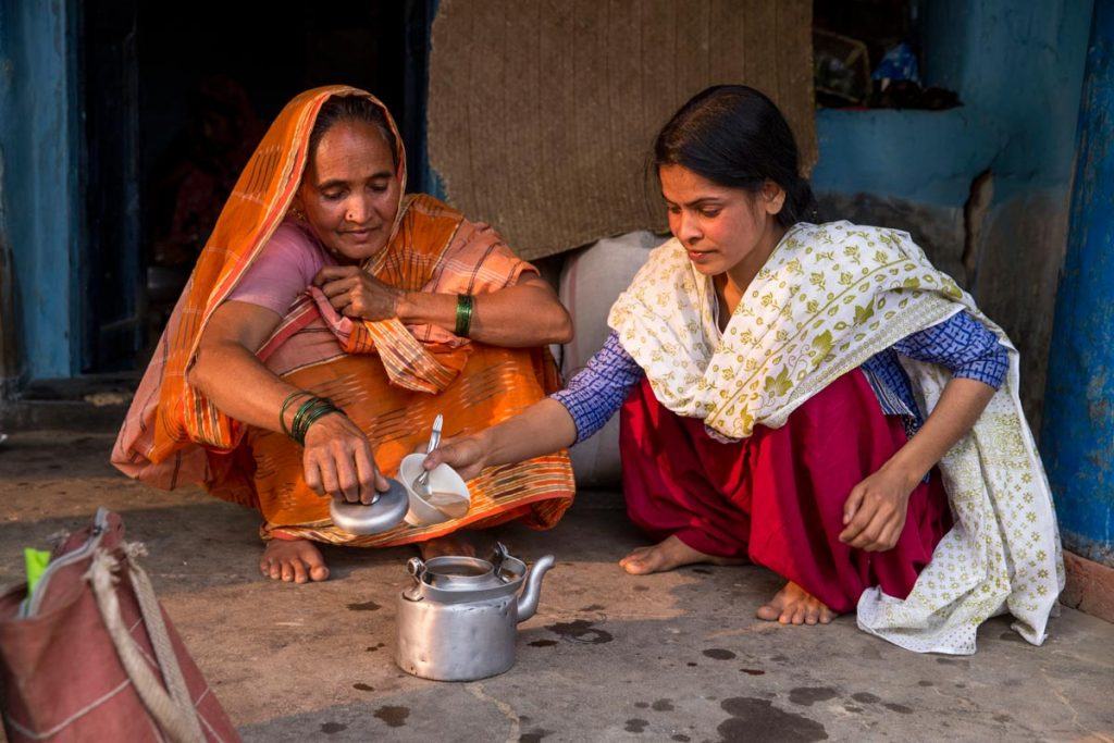 Sonali Khatun, right, prepares chai with her mother in rural West Bengal. Forced to marry at age 14, Sonali convinced her parents to let her divorce. With support from AJWS grantee MBBCDS, she has weathered the intense stigma against divorce in her community and started counseling other girls on their rights. Photo by Jonathan Torgovnik