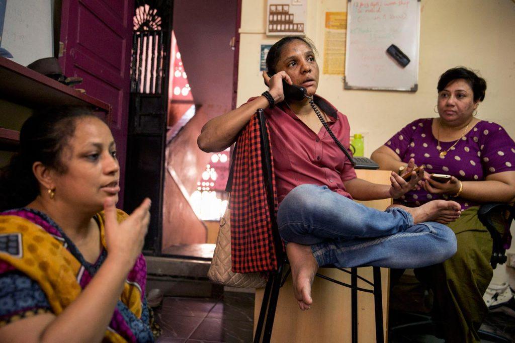 On the phone, Kausar Ansari negotiates to arrange last-minute bicycle rentals for an Awaaz rally. Awaaz staff suspect the previous arrangement fell through because men who oppose gender equality pressured local businesses not to rent Awaaz the bicycles.